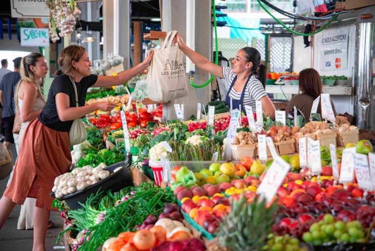 Familia observa precios de carne y verduras en supermercado tras aumento de la canasta alimentaria